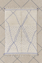 Tapis berbère en laine blanc avec motifs bleus